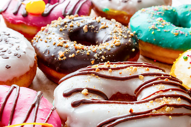 istock Donut in white glaze drizzled with chocolate close up 534053540