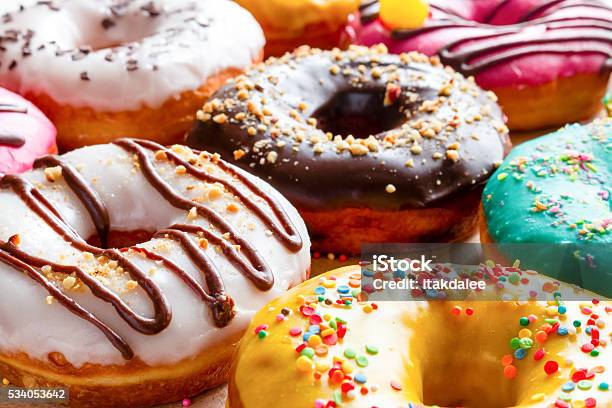 Donuts In Multicolored Glaze Closeup Stock Photo - Download Image Now - Doughnut, Bakery, Sweet Food