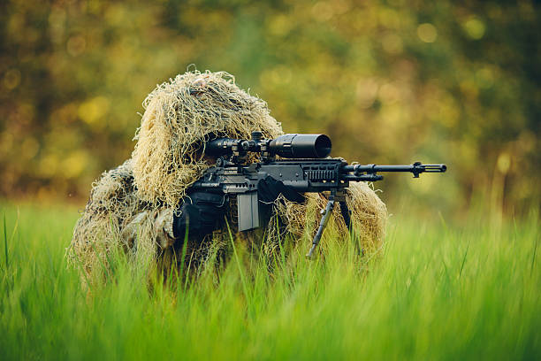 istock sniper in camouflage suit looking at the target 534053709