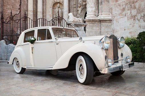 Valencia, Spain - Juny 16th, 2013: Rolls Royce decorated for wedding in front of the harbor in the cathedral of Valencia.