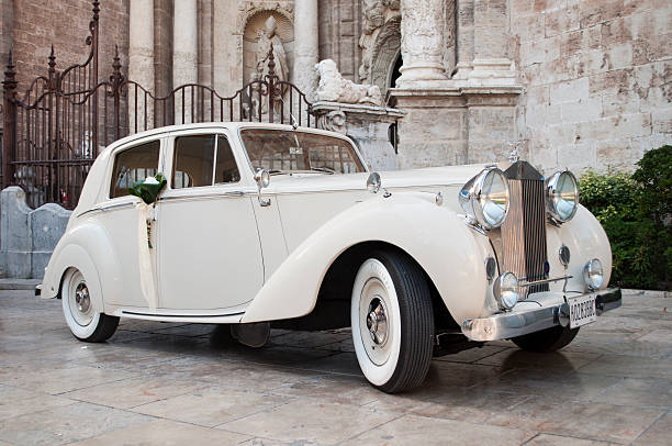 Rolls Royce Valencia, Spain - Juny 16th, 2013: Rolls Royce decorated for wedding in front of the harbor in the cathedral of Valencia. rolls royce stock pictures, royalty-free photos & images