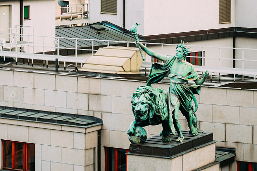 Statue on roof of entrance to the bank Czech National Bank (Ceska narodni banka, CNB) in Prague, Czech Republic
