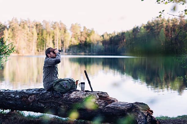 istock Hiker Birdwatching By The Lake During Sunset 534054812