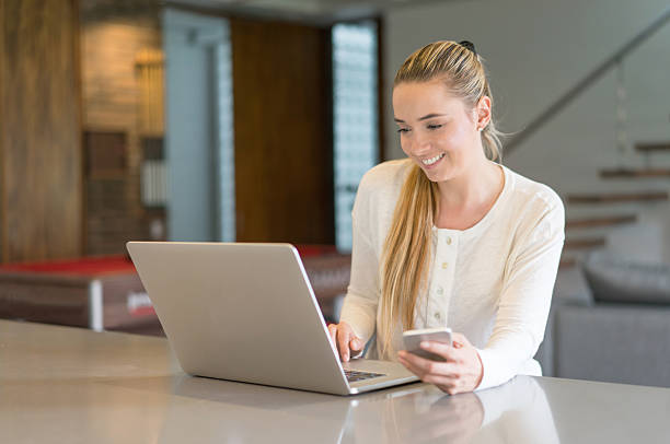 Free Stock Photo of A young blonde woman working on her laptop ...