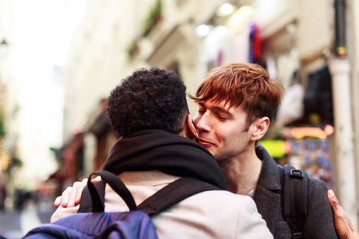 Young adults kissing in the streets of Paris
