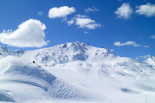 Winter snow mountain alpine peaks with ski slopes High French Alps mountain range panorama view with ski slopes in La Plagne resort la plagne photos stock pictures, royalty-free photos & images
