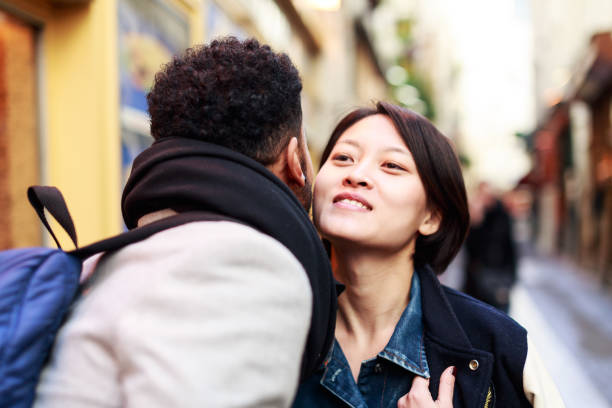 Young adults kissing in the streets of Paris stock photo