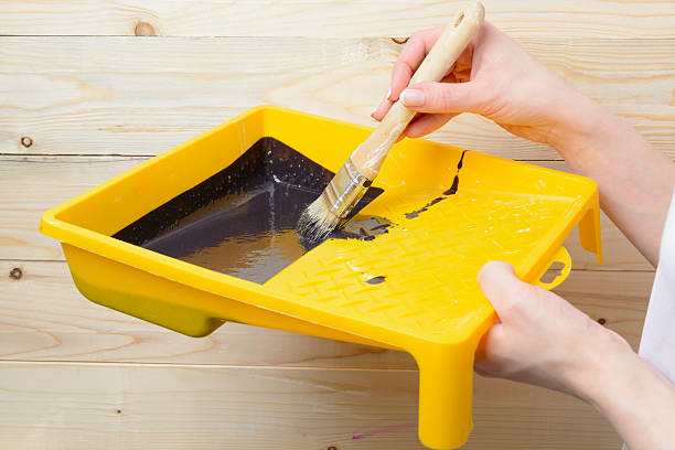 istock Woman is holding a brush and paint tray 534058606