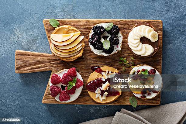 Variety Of Bagels On A Board Stock Photo - Download Image Now - Baked, Baked Pastry Item, Bakery