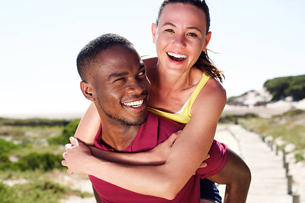 istock Happy young man carrying attractive girlfriend on his back 534059026