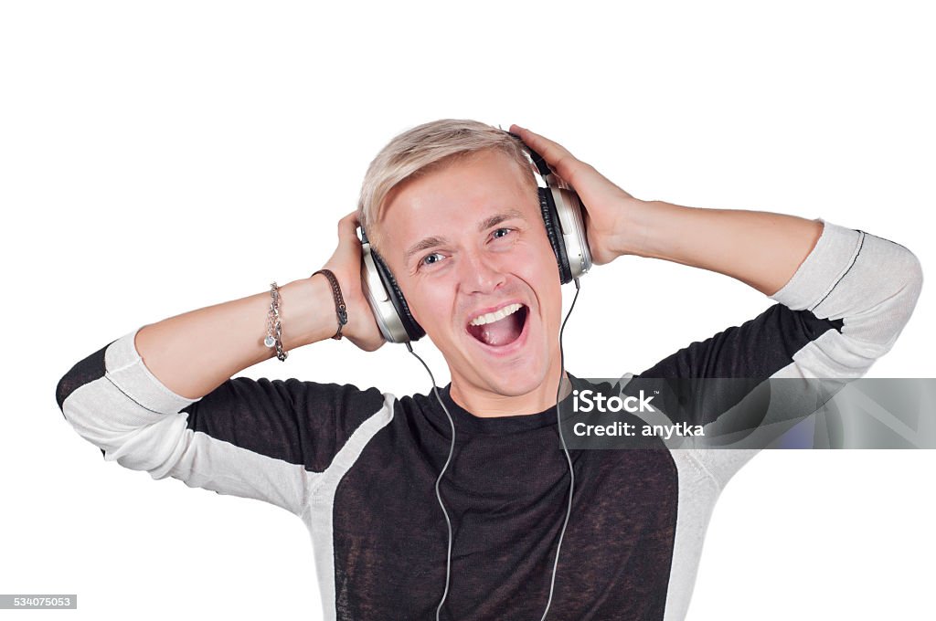 Young handsome man singing with headphones Young handsome man singing with headphones isolated over white 2015 Stock Photo