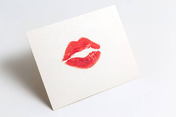 istock Lipstick kiss on white paper sheet 534080175