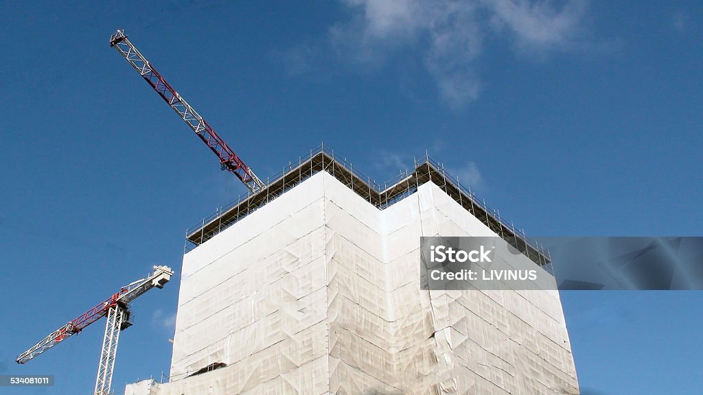 Concrete Highrise Construction Site Reinforced steel & concrete building under construction. Safety guard rails, flyforms and tower crane 2015 Stock Photo