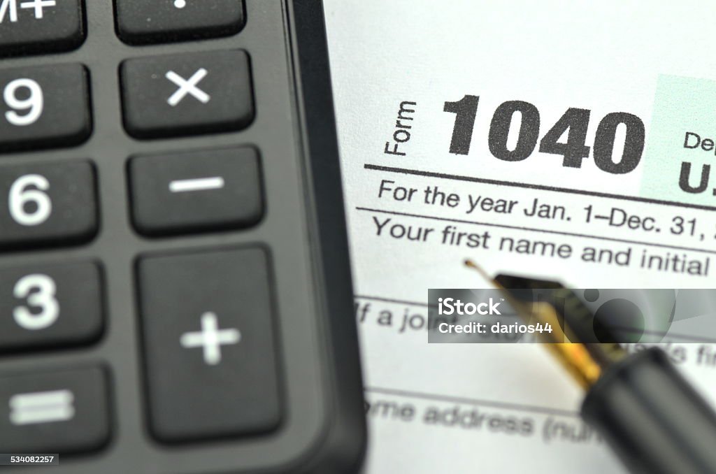 closeup of us tax form, pen and calculator 1040 Tax Form Stock Photo