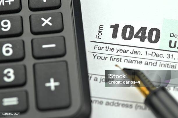 Closeup Of Us Tax Form Pen And Calculator Stock Photo - Download Image Now - 1040 Tax Form, 2014, 2015
