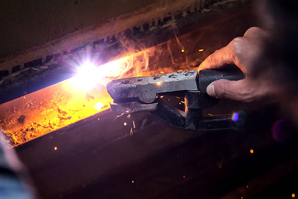 istock welding steel with spread spark lighting smoke 534082671
