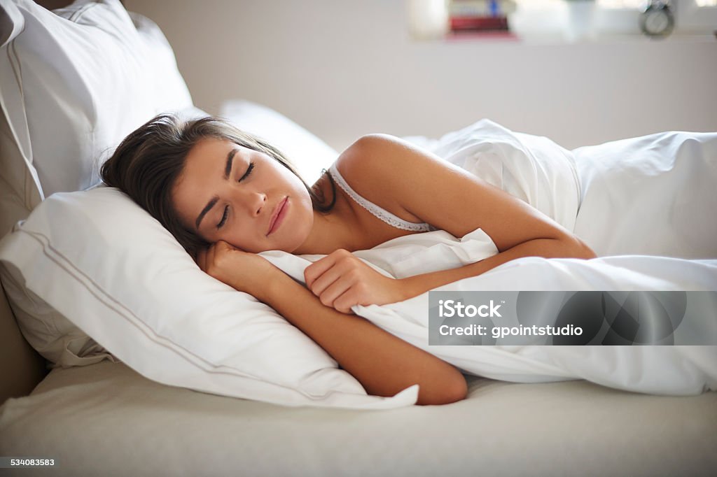 Beautiful young woman sleeping in bed Sleeping Stock Photo