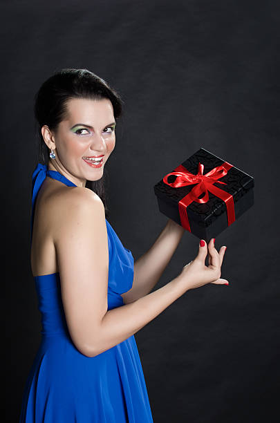 istock Happy beautiful woman showing a gift box 534085341