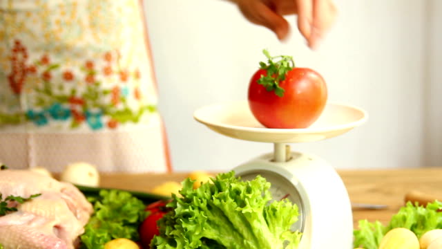 kitchen scales and fresh vegetables