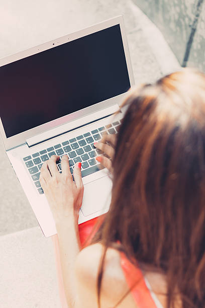istock Girl using laptop outdoors 534097645