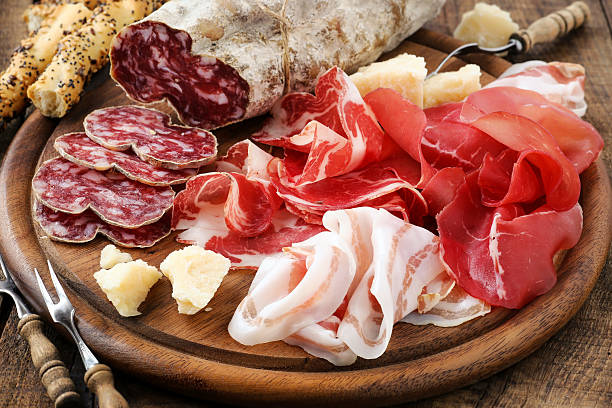 Italiam cured meat variety Italian meat platter - prosciutto ham, bresaola, pancetta, salami and parmesan salami stock pictures, royalty-free photos & images