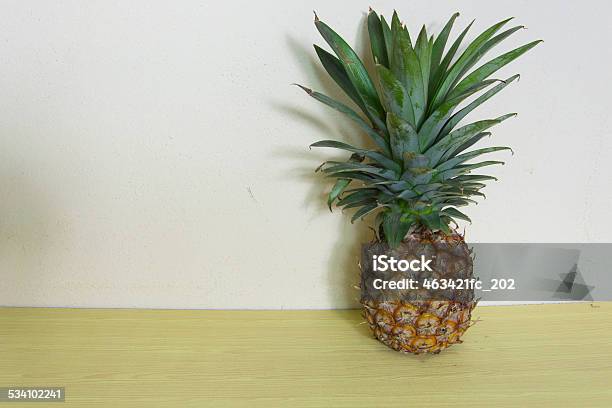 Pineapple On Wooden Table Over Grunge Background Stock Photo - Download Image Now - 2015, Above, Abstract