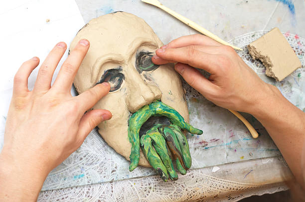 istock Hands sculpting plasticine form of face 534104115