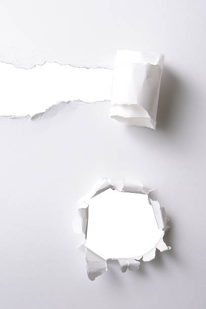 istock Two different holes in white paper against white background 534105273