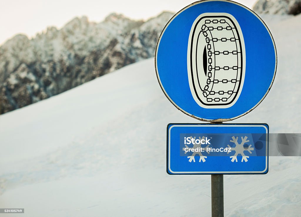 Snow Chains Sign Snow chains sign with mountains in the background. Chain - Object Stock Photo