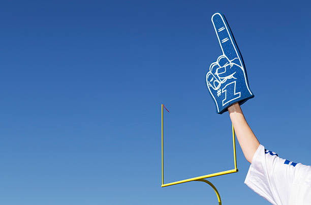 Tailgating Football Fan Tailgating football fan with number 1 foam finger and stadium goal post in the background with copy space.  Please see my portfolio for other sports related images. tailgate party photos stock pictures, royalty-free photos & images