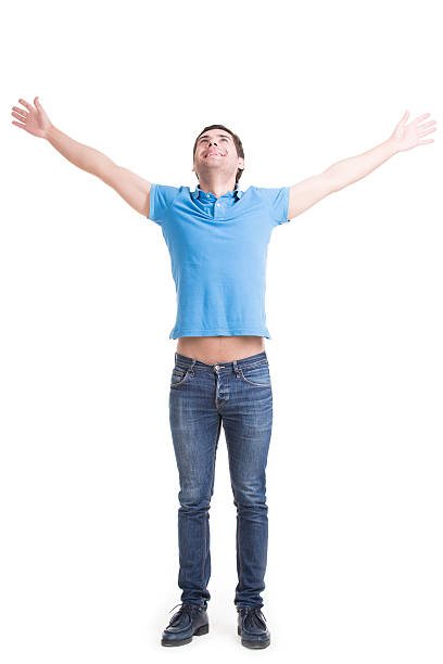 istock Young happy man in casuals with raised hands up. 534107219