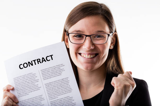 istock smiling woman holding a contract 534112662