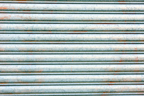 Closeup weathered dirty corrugated iron background, full frame horizontal composition with copy space