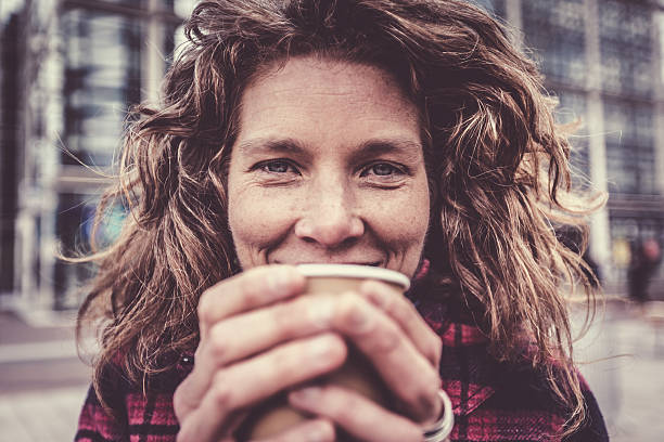 istock Woman in her forties warming her hands on coffee cup 534113414