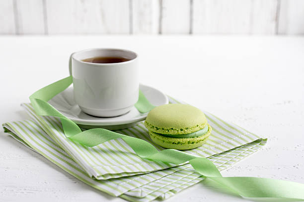 istock Cup of tea and green French macaroons 534113478