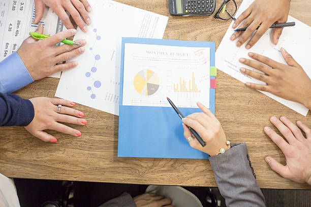 istock Close up of business graphs and papers on a table 534114430