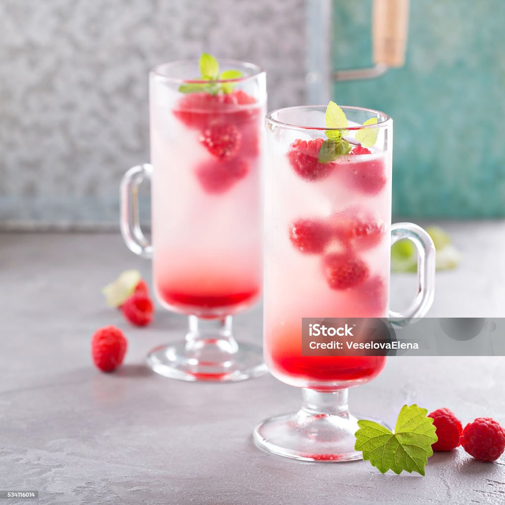 Pink raspberry lemonade in tall glasses Pink refreshing cold raspberry lemonade in tall glasses Backgrounds Stock Photo