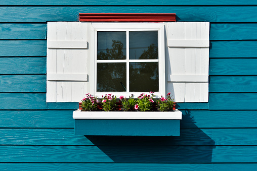 House window and flowers, seen in Graubunden, Vals