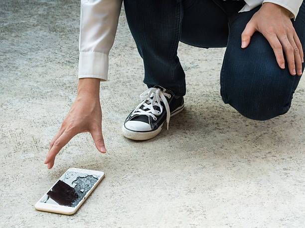 istock Person Picking Broken Smart Phone of Ground 534117904