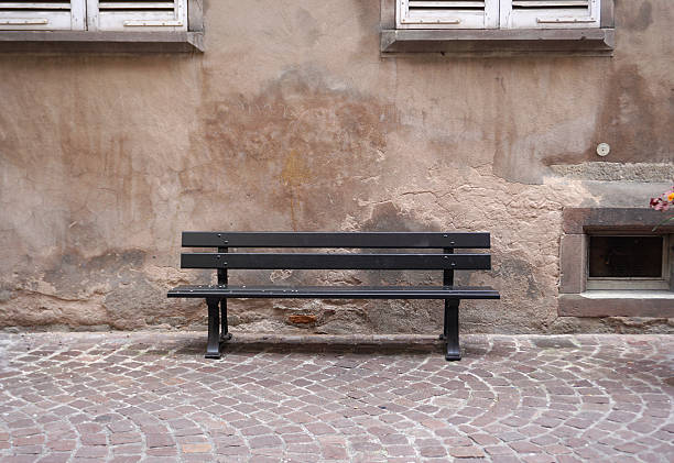 istock Dark Brown color outdoor bench with rustic wall 534118600