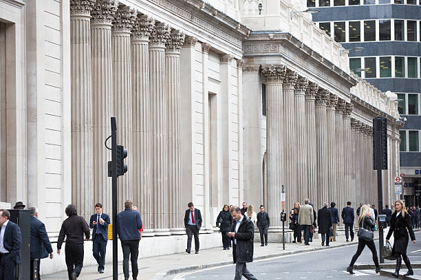 Business people walking by the Bank of England London, UK - October 14, 2015: Business people walking by the Bank of England. Business life of City of London bank of england stock pictures, royalty-free photos & images