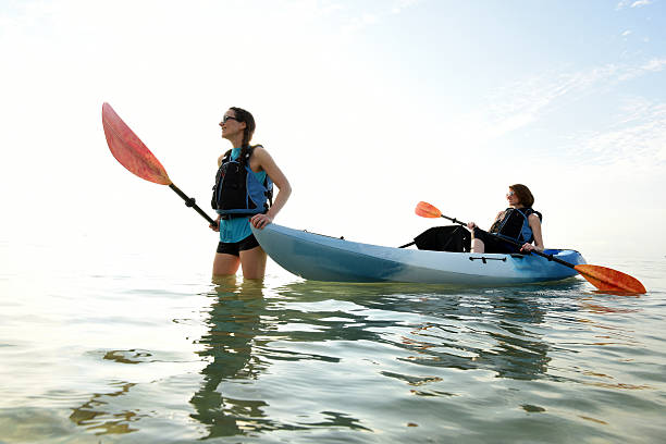 istock Two young women and blue kayak in Atlantic Ocean 534120138