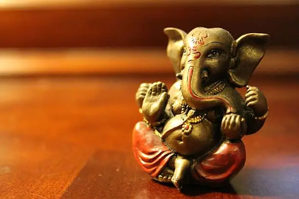 Close up of a miniature figurine of Lord Ganesh from hindu mythology and religion.  