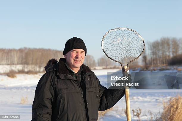 Fisherman With Ice Fishing Skimmer Stock Photo - Download Image Now - Activity, Adult, Adults Only