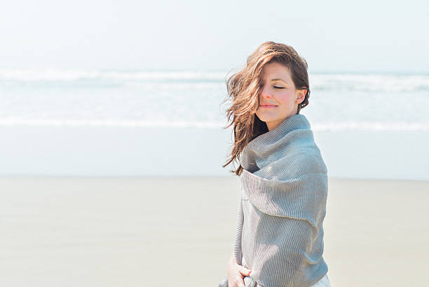 istock Woman on Windy Beach Wrapped in Shawl 534122816