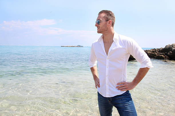 istock Young man standing next to the sea 534124650