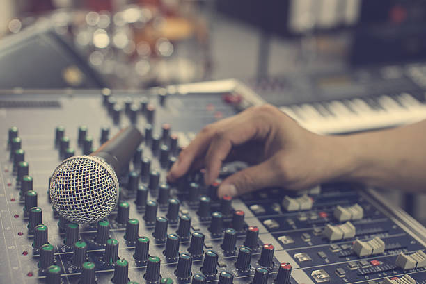 istock music equipment mic and blur hand adjust audio mixer 534125606