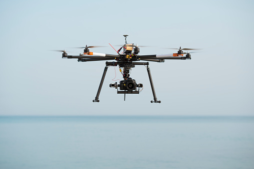 Radio control octocopter (Drone/ UAV) carrying SLR professional camera  in the mid-air.