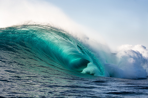 Big wave barrel unloads in the surf.