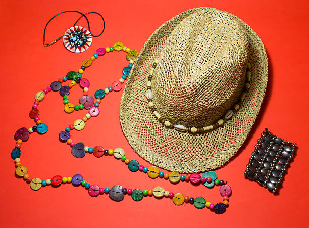 A pile of traditional straw hats in a souvenir shop in Transylvania, Romania. The hats are decorated with a ribbon on which are the colors of the Romanian flag.